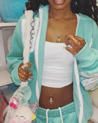 a young woman wearing a green jacket and teddy bears