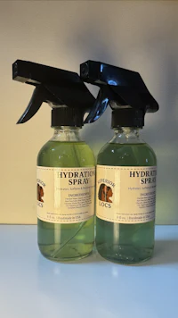 two bottles of hydrotherapy spray on a table